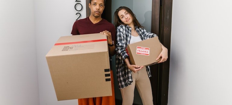 A man and a woman with packed boxes